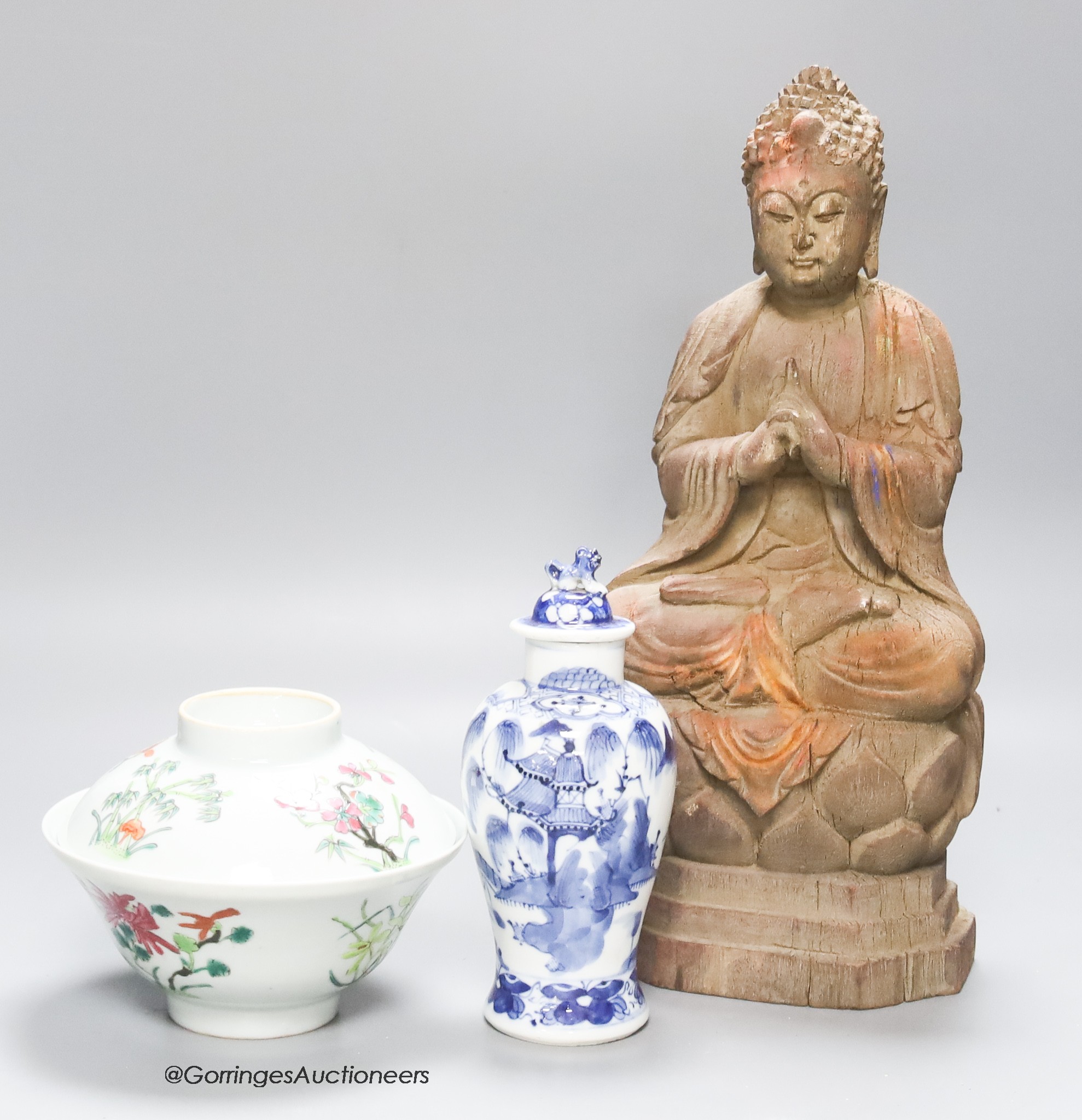 A 20th century carved wooden Buddha, height 34cm, a 19th century Chinese blue and white lidded vase, and a famille rose bowl and cover